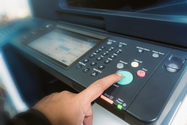 Man touch startup copying paper from Photocopier with access con
