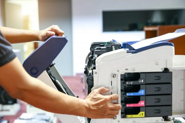 Technician hand open cover photocopier or photocopy to fix paper
